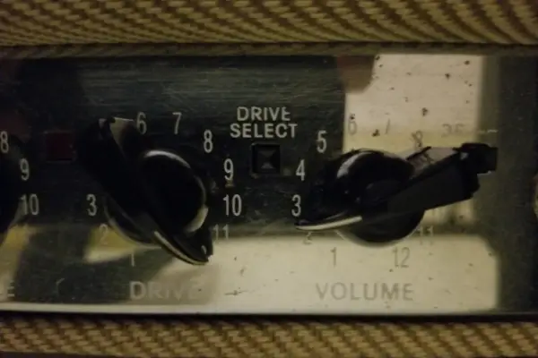 The drive and volume knobs on a Fender amp